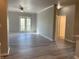 Bright living room featuring wood floors, ceiling fan, and French doors to the outside balcony at 12873 Tradd St # 2B, Carmel, IN 46032