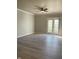 Spacious living room with light gray flooring and modern ceiling fan at 12873 Tradd St # 2B, Carmel, IN 46032