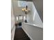 Entryway staircase featuring an ornate chandelier and natural light from the front door at 12873 Tradd St # 2B, Carmel, IN 46032