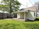 Backyard featuring a covered porch and green lawn at 1303 9Th St, Columbus, IN 47201
