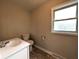 Bright bathroom featuring a white vanity, toilet, and window, complemented by neutral wall colors at 1303 9Th St, Columbus, IN 47201