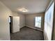 Sunlit bedroom features plush gray carpeting, neutral walls, and natural light from large windows, creating a calming retreat at 1303 9Th St, Columbus, IN 47201