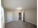 Bedroom boasts neutral paint, plush carpeting, and natural light, creating a relaxing and inviting atmosphere at 1303 9Th St, Columbus, IN 47201