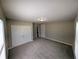 A spacious bedroom features neutral paint and carpet, a double closet, and ample natural light at 1303 9Th St, Columbus, IN 47201