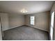 The well-lit bedroom offers a window, plush carpeting, and neutral paint, creating a comfortable and inviting space at 1303 9Th St, Columbus, IN 47201
