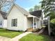Charming home featuring light siding, a dark roof, and a cozy front porch at 1303 9Th St, Columbus, IN 47201