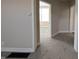 Hallway view showing the neutral color palette and plush carpet, leading to rooms with plenty of natural light at 1303 9Th St, Columbus, IN 47201