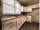 A close up view of the kitchen's new cabinets, countertops and large window at 1303 9Th St, Columbus, IN 47201