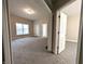 Open concept living room and hallway with neutral paint, plush carpeting, and natural light at 1303 9Th St, Columbus, IN 47201