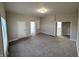 Spacious living room offers a bright, airy space with carpet flooring and neutral colors at 1303 9Th St, Columbus, IN 47201