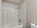 Clean bathroom featuring a tiled shower and tub with white fixtures at 1467 W 33Rd St, Indianapolis, IN 46208