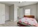 A comfortable bedroom with neutral walls, wood style flooring, ceiling fan and an ensuite bathroom at 1467 W 33Rd St, Indianapolis, IN 46208