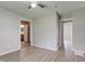 Bedroom with sleek floors, neutral paint, and adjoining bath/hallway entrances at 1467 W 33Rd St, Indianapolis, IN 46208