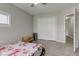 Cozy bedroom features wood style flooring and ample closet space with a view into another room at 1467 W 33Rd St, Indianapolis, IN 46208