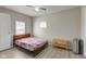 Bedroom featuring neutral walls, ceiling fan, wood style floor and natural light from two windows at 1467 W 33Rd St, Indianapolis, IN 46208
