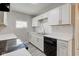 Beautiful kitchen with white cabinets, modern countertops, and stainless steel appliances at 1467 W 33Rd St, Indianapolis, IN 46208