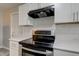 Stainless steel oven range with white cabinetry and subway tile backsplash at 1467 W 33Rd St, Indianapolis, IN 46208
