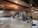 Unfinished basement with exposed wooden beams and concrete flooring, offering potential for customization and additional living space at 1506 Field Dr, Noblesville, IN 46060