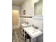 Classic bathroom with pedestal sink, framed mirror, and decorative accents, offering a timeless aesthetic at 1506 Field Dr, Noblesville, IN 46060