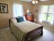 Well-lit bedroom featuring dual windows, with a cozy bed, dresser and desk, perfect for relaxation at 1506 Field Dr, Noblesville, IN 46060