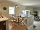 Bright dining area featuring a glass table and chairs, with natural light streaming through the window at 1506 Field Dr, Noblesville, IN 46060