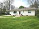 Charming one-story home with a well-manicured lawn, walkway, and inviting front entrance at 1506 Field Dr, Noblesville, IN 46060