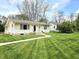 Well-maintained lawn leads to a charming home exterior and walkway at 1506 Field Dr, Noblesville, IN 46060
