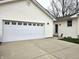 Attached garage with a large white door and concrete driveway, complemented by the home's siding at 1506 Field Dr, Noblesville, IN 46060
