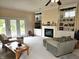 Cozy living room features comfortable seating, a fireplace, and access to the outdoors through glass doors at 1506 Field Dr, Noblesville, IN 46060