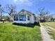A quaint single story home with blue trim and a stone path at 1525 Home Ave, Anderson, IN 46016
