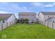 Large grassy backyard with patio, fire pit area, and privacy fence at 15332 Atkinson Dr, Noblesville, IN 46060