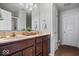 Bathroom vanity with double sinks, modern lighting, and neutral decor next to a white door at 15332 Atkinson Dr, Noblesville, IN 46060