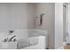 Bathroom with white tile tub, brushed metal faucet, and a glass shower door at 15332 Atkinson Dr, Noblesville, IN 46060