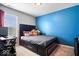 Comfortable bedroom with modern bed frame, blue accent wall, and window at 15332 Atkinson Dr, Noblesville, IN 46060