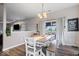 Open dining area with natural light, wood floors, and a view into the living area for easy entertaining at 15332 Atkinson Dr, Noblesville, IN 46060