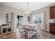 Bright dining area with wood floors, stylish lighting, and sliding door access to the outdoor patio at 15332 Atkinson Dr, Noblesville, IN 46060