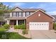 Charming two-story home featuring a well-manicured lawn, brick accents, and an attached two-car garage in a residential area at 15332 Atkinson Dr, Noblesville, IN 46060