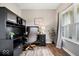 Well-lit home office featuring built-in shelving, wood floors, and a comfortable workspace at 15332 Atkinson Dr, Noblesville, IN 46060