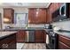 Well-appointed kitchen featuring stainless steel appliances, dark cabinets, granite countertops, and modern fixtures, ready for culinary adventures at 15332 Atkinson Dr, Noblesville, IN 46060