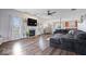Spacious living room with hardwood floors, a cozy fireplace, large windows, and comfortable seating, great for entertaining at 15332 Atkinson Dr, Noblesville, IN 46060