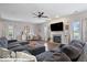 Bright living room featuring a fireplace, hardwood floors, stylish furniture, and large windows, perfect for relaxation and gatherings at 15332 Atkinson Dr, Noblesville, IN 46060