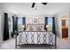 Bright main bedroom with a comfortable bed, soft carpeting, and an attached bathroom for convenience at 15332 Atkinson Dr, Noblesville, IN 46060