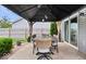 Covered patio with dining table, chairs, and lush landscaping at 15332 Atkinson Dr, Noblesville, IN 46060