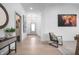 Inviting foyer boasts stylish decor, neutral paint, an artistic highland cow print and hardwood floors at 15882 Vitalize Run, Fishers, IN 46040