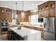 Gorgeous kitchen with stainless appliances, custom wood cabinets, large island and designer pendant lights at 15882 Vitalize Run, Fishers, IN 46040