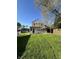 View of the back of the home with a covered patio and well-maintained lawn at 1641 English Ave, Indianapolis, IN 46201