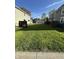 Large grass backyard between houses with a garage in the background at 1641 English Ave, Indianapolis, IN 46201