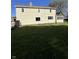 Expansive backyard with sunny lawn and view of the home's rear exterior at 1641 English Ave, Indianapolis, IN 46201
