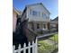 Side view of home with wood privacy fence, chain link fence and partially covered front porch at 1641 English Ave, Indianapolis, IN 46201