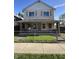 Charming two-story home featuring a covered porch with brick columns and fenced front yard at 1641 English Ave, Indianapolis, IN 46201
